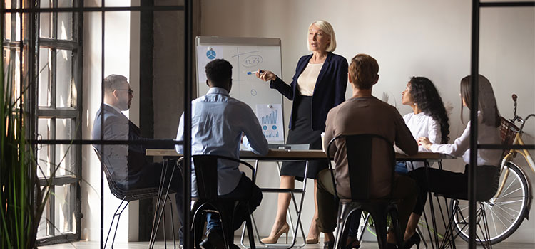 A professor talks to students during a seminar.