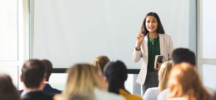 A female manager leads a meeting for other employees.