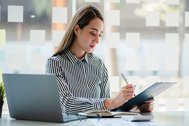 woman actuary assesses risk on client file