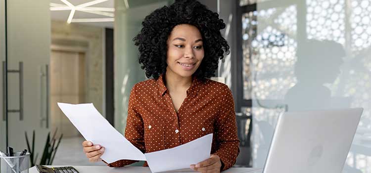 cpa prepares paperwork for client in her office