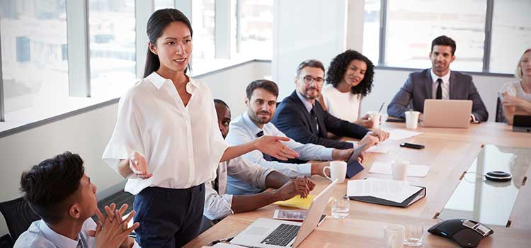business meeting with female executive addressing the room