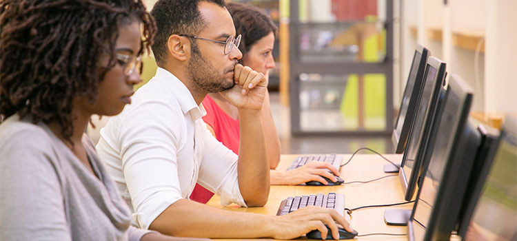 adults take a test on their laptops