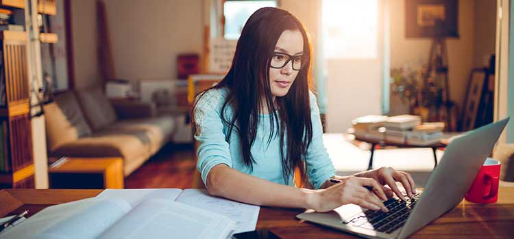 woman studying for degree online using laptop