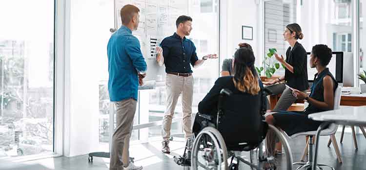 man presenting data on whiteboard in casual meeting