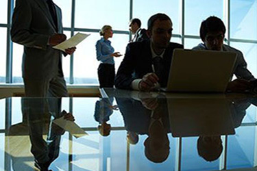 team of accountants gather around glass conference table