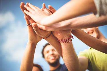 leadership team high five each other