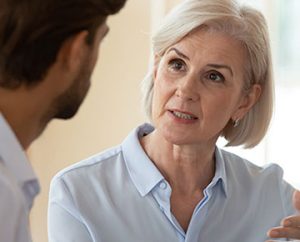 woman speaks with coworker