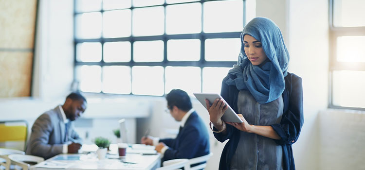 A woman reads on her laptop
