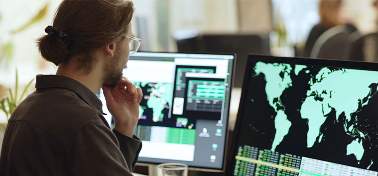 A man looks at images of the world on a laptop