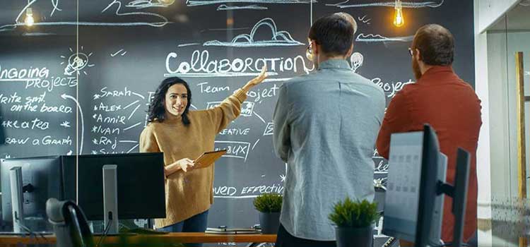 woman reviews project tasks with team at standup