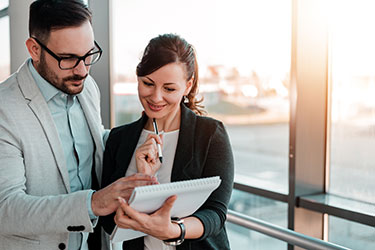 A property manager looks over notes with a business associate.
