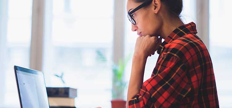 woman filling out licensing forms on laptop