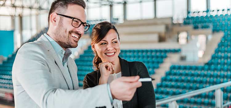 sports manager surveys sports arena with facilities manager