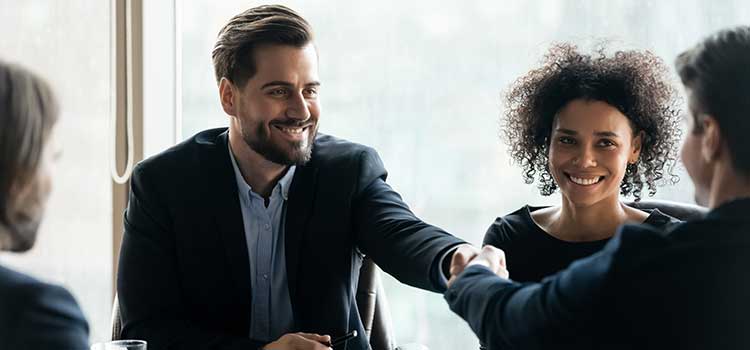 man in suit shaking hands with agent