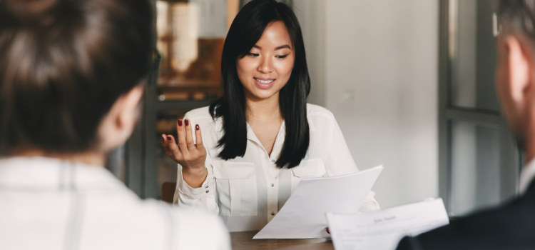 woman being interviewed by two interviewers