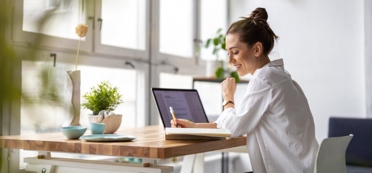 woman studying online at a brightly lit space